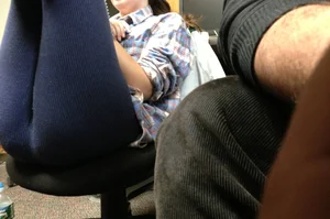 Girl in Tights Sitting on an Office Chair With Raised Legs