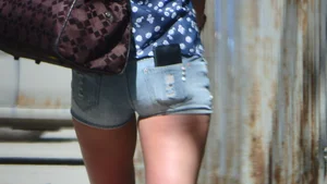Amazing butt of a street candid girl wearing denim mini shorts passing by