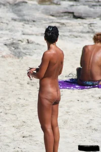 Smoking milf at a nude beach with a hairy pussy