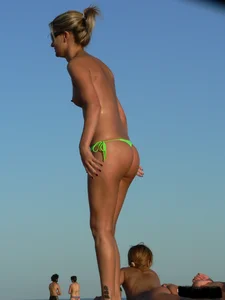 Bunch of sexy babes on the beach topless and in thong bikinis