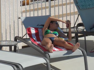 Hot milf sunbathing in a thong by pool and swimming