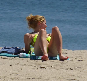Sexy ass blonde milf on the beach in a thong with cameltoe and bending over