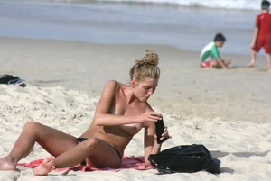 Sexy girls topless on a nude beach showing their nice tits