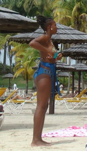 Sexy black babe in various bikinis on the beach while on vacation