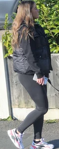 Pouting brunette teen in black leggings