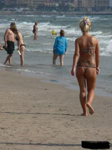 Tattooed blonde with big tits topless and in thong