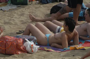 Topless girls on a beach in Barcelona