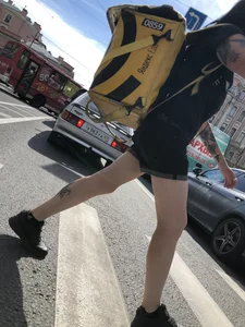 Amazing cute candid food delivery girl with lots of tattoos crossing the street