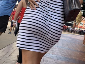Bunch of girls in various outfits at a Cardinals baseball game