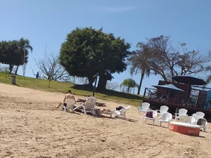 Blonde beach girl with a great ass in pink thong bikini