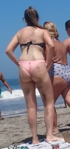 Chunky beach blonde babe in a pink thong bikini