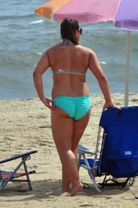 Thick beach girl in a teal bikini
