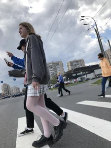 Candid teen girl wearing a skirt and white pantyhose crossing the street creepshots