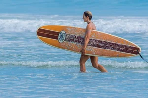 Candid girls surfing on the beach