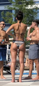 Fit brunette spotted at the pool in a cheeky bikini