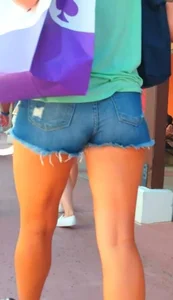 Candid girl in denim shorts with nice legs and showing her cheeks
