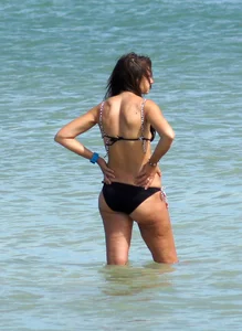 Older mature beach lady in a black bikini