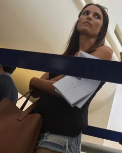 Sexy brunette waiting in line with short jean shorts