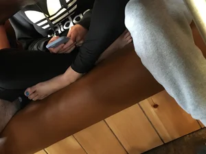Barefoot Girl Sitting Squat Cross-legged in the Cafe Under Table Creepshot