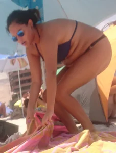 Thick brunette beach babe booty in a little black bikini