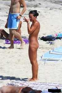 Smoking milf at a nude beach with a hairy pussy