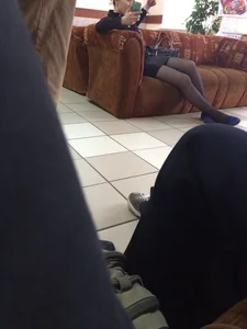 Skinny Legs of a Candid College Teen Chilling on a Couch in a Skirt, Flats And Black Pantyhose