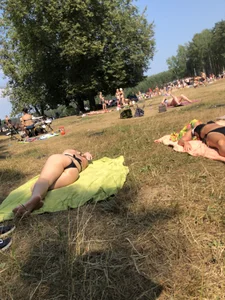 Girl in a Swimsuit Lying on Grass in a Nature Park