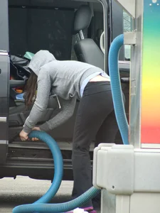 Girls cleaning their cars in jeans and pants