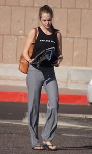 Sexy girl in the parking lot in tight grey sweatpants