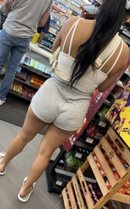 Sexy fit latina with cheeks coming out of booty shorts