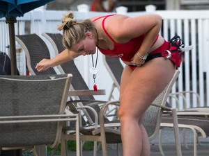 Thick blonde lifeguard in red swimsuit
