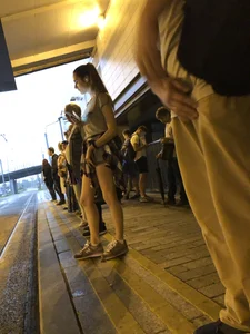Cute Teen in Shorts on the Tram Stop