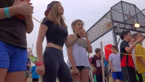 Beautiful teen girl in grey spandex dancing at amusement park
