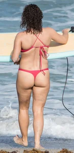 Thick brunette milf on the beach in red thong bikini