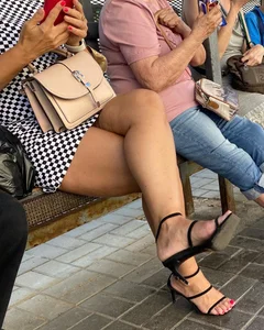 Candid hot blonde milf wearing high heels and red nail polish while showing sexy legs in short dress