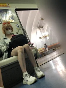 Masked Girl in Sneakers With Nice Legs Sitting in a Subway Train Creepshots
