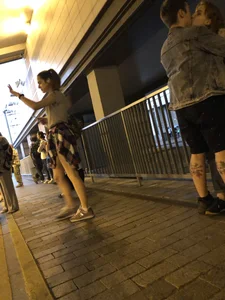 Cute Teen in Shorts on the Tram Stop