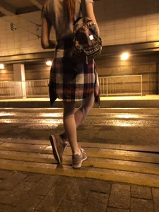 Cute Teen in Shorts on the Tram Stop