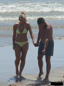 Sexy blonde on the beach in a yellow thong bikini