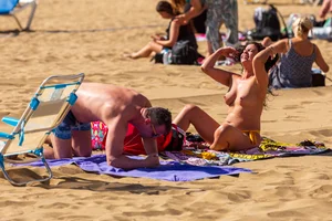 Topless milf at the beach
