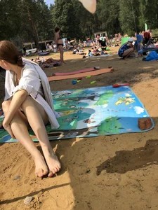 Skinny Girl Sitting Under a Towel at a Beach Photos