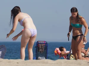 2 cute friends in bikinis on the beach