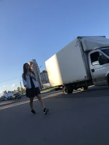 Extremely Cute Girl in a Skirt With a Backpack Passing By on the Street Gallery