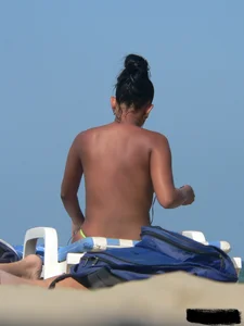 Hot ass topless beach girl with great tits lets her little brother oil up her ass in thong bikini