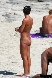 Smoking milf at a nude beach with a hairy pussy