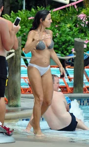 Sexy brunette lady with nice tits at the pool in a semi thong bikini