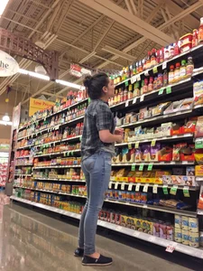 Sexy brunette grocery shopping in tight jeans