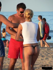 A bunch of hot babes on the beach in thong bikinis
