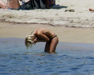 Small boobed topless milf on the beach