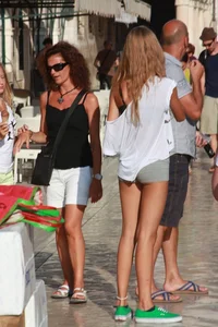 Sexy skinny blonde eating ice cream in short tight grey shorts